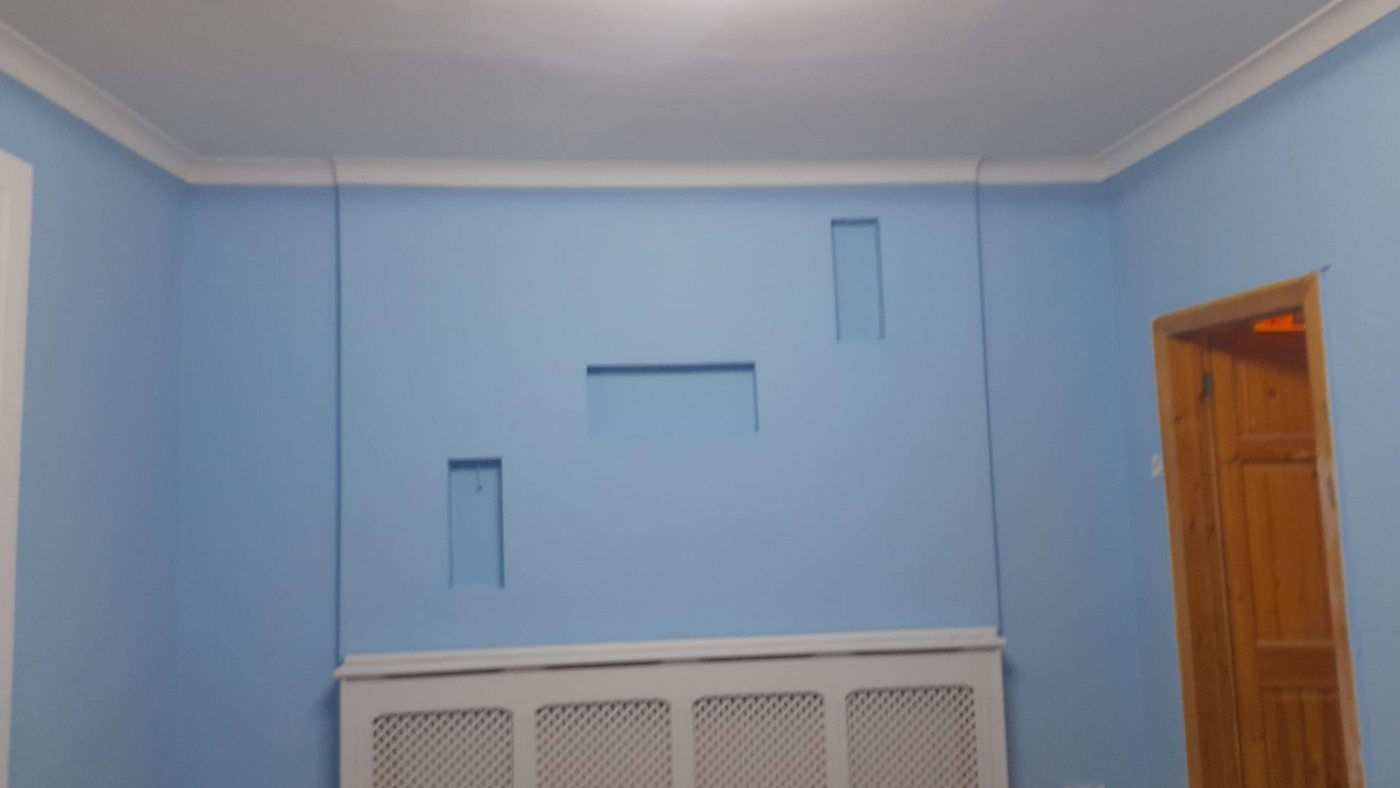 Front room painted in blue with white cornice and skirting
